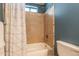 Bathtub with tiled surround and shower head, perfect for relaxation at 3133 E Claire Dr, Phoenix, AZ 85032