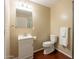 Neutral bathroom features a single sink vanity, toilet, and a large framed mirror at 3133 E Claire Dr, Phoenix, AZ 85032