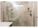 Modern shower with glass enclosure, rain shower head, and built-in shelving at 3133 E Claire Dr, Phoenix, AZ 85032