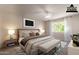 Staged bedroom featuring a king bed, bench, and neutral decor at 3133 E Claire Dr, Phoenix, AZ 85032