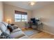 Bedroom staged as an office with a comfy couch and desk at 3133 E Claire Dr, Phoenix, AZ 85032