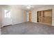Empty bedroom with carpet and a closet with wooden drawers at 3133 E Claire Dr, Phoenix, AZ 85032