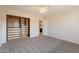 Neutral bedroom with an organized closet, carpeted floors, and access to an ensuite bath at 3133 E Claire Dr, Phoenix, AZ 85032