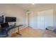 Bright bedroom featuring hardwood floors, a work area, and a closet with sliding doors at 3133 E Claire Dr, Phoenix, AZ 85032