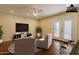 Staged bonus room with a ceiling fan, French doors and comfortable seating at 3133 E Claire Dr, Phoenix, AZ 85032