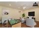 Staged bonus room with ceiling fan, TV, foosball table, and comfortable seating at 3133 E Claire Dr, Phoenix, AZ 85032