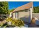 Exterior of the detached building with a brick walkway, white wall, and green foliage at 3133 E Claire Dr, Phoenix, AZ 85032