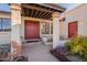 A front entrance with Southwest decor, a red door, and desert landscaping welcomes visitors at 3133 E Claire Dr, Phoenix, AZ 85032