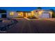 Charming home featuring desert landscaping, warm exterior lighting, and a welcoming front entrance at 3133 E Claire Dr, Phoenix, AZ 85032