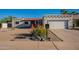 Home with desert landscaping and a garage, all illuminated by the sun, showcases the outdoor charm at 3133 E Claire Dr, Phoenix, AZ 85032