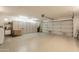 Spacious garage with white epoxy floors, built-in cabinets, and overhead lighting at 3133 E Claire Dr, Phoenix, AZ 85032