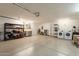 Spacious garage with white epoxy floors, shelving, and laundry hookups at 3133 E Claire Dr, Phoenix, AZ 85032