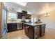 Well-equipped kitchen with dark cabinetry, stainless steel appliances, and island with seating at 3133 E Claire Dr, Phoenix, AZ 85032