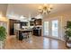 Spacious kitchen with dark cabinets, island, and eat-in area with lots of natural light from French doors at 3133 E Claire Dr, Phoenix, AZ 85032