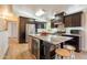 Modern kitchen with dark cabinets, granite countertops, stainless steel appliances, and an island at 3133 E Claire Dr, Phoenix, AZ 85032