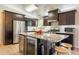 Modern kitchen features dark wood cabinetry, stainless steel appliances, and granite countertops at 3133 E Claire Dr, Phoenix, AZ 85032