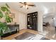 Comfortable living room with wooden floors, built-in shelves, and an arched doorway at 3133 E Claire Dr, Phoenix, AZ 85032