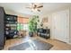 Bright living room with large plants, wooden floors, and a ceiling fan at 3133 E Claire Dr, Phoenix, AZ 85032