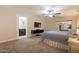 Bedroom featuring an ensuite bathroom, ceiling fan, and mounted TV at 3133 E Claire Dr, Phoenix, AZ 85032