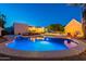 An inviting pool with a hot tub and a well-lit deck area offers the perfect outdoor retreat at 3133 E Claire Dr, Phoenix, AZ 85032