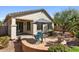 Landscaped backyard featuring a patio with outdoor seating, desert vegetation and an outdoor ceiling fan at 31716 N Poncho Ln, San Tan Valley, AZ 85143