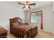 Comfortable bedroom with a ceiling fan, a bed with a decorative comforter, and a large window at 31716 N Poncho Ln, San Tan Valley, AZ 85143