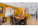Dining area with a wooden table and chairs set, with yellow paint, and tile floors at 31716 N Poncho Ln, San Tan Valley, AZ 85143