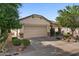 Exterior facade with a spacious driveway leading to a two-car garage, complemented by desert landscaping at 31716 N Poncho Ln, San Tan Valley, AZ 85143
