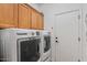 Laundry room featuring a washer, a dryer, and overhead cabinets at 31716 N Poncho Ln, San Tan Valley, AZ 85143