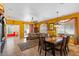 Open-concept living and dining area with tile flooring, abundant natural light, and a cozy sofa at 31716 N Poncho Ln, San Tan Valley, AZ 85143