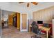 Bright home office featuring tile floors, ceiling fan, large window and an office chair at 31716 N Poncho Ln, San Tan Valley, AZ 85143