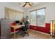 Bright home office featuring tile floors, ceiling fan, large window and an office chair at 31716 N Poncho Ln, San Tan Valley, AZ 85143