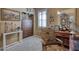 Cozy room features a decorative chair, storage and desk space with natural light at 3212 E Desert Cove Ave, Phoenix, AZ 85028
