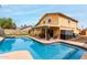 Beautiful backyard featuring a private pool, covered patio, well-maintained lawn, and a charming home exterior at 3358 W Sandra Ter, Phoenix, AZ 85053