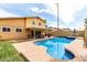 Resort-style backyard featuring a sparkling pool, covered patio, and a serene outdoor space, ideal for entertaining at 3358 W Sandra Ter, Phoenix, AZ 85053