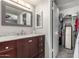 Bathroom with cherry wood vanity, marble countertops and walk-in closet at 3358 W Sandra Ter, Phoenix, AZ 85053