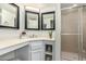 Bright bathroom featuring dual mirrors, vanity with ample counter space, and a glass-enclosed shower stall at 3358 W Sandra Ter, Phoenix, AZ 85053