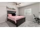 Cozy bedroom offering a comfortable bed, a ceiling fan, a window, and a dedicated workspace at 3358 W Sandra Ter, Phoenix, AZ 85053