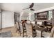 A dining room features stylish décor, a ceiling fan, and an elegant cabinet for glassware at 3358 W Sandra Ter, Phoenix, AZ 85053