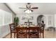 Elegant dining room featuring a stylish light fixture, a plant, an arched doorway and seating for eight at 3358 W Sandra Ter, Phoenix, AZ 85053