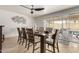 A dining room features stylish décor, a ceiling fan, and sliding glass doors leading to the backyard and pool at 3358 W Sandra Ter, Phoenix, AZ 85053