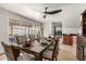 A dining room features sliding glass doors to the backyard, stylish décor, and a ceiling fan at 3358 W Sandra Ter, Phoenix, AZ 85053