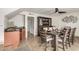 A dining room features a stylish dining set, elegant cabinet, and a bar sink with countertop at 3358 W Sandra Ter, Phoenix, AZ 85053
