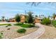 Well-kept front yard featuring a manicured lawn, mature trees, and a charming brick walkway at 3358 W Sandra Ter, Phoenix, AZ 85053