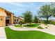 Lush front yard with a manicured lawn, brick walkway, and charming seating area by the entrance at 3358 W Sandra Ter, Phoenix, AZ 85053