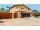 Home featuring a two-car garage, gated driveway, and landscaped front yard with palm trees at 3358 W Sandra Ter, Phoenix, AZ 85053