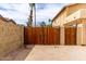 Secured backyard entrance with a sturdy wooden gate and block wall, providing privacy at 3358 W Sandra Ter, Phoenix, AZ 85053