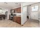 An open-concept kitchen boasts stainless steel appliances, stylish cabinets and flooring, and granite countertops at 3358 W Sandra Ter, Phoenix, AZ 85053
