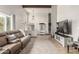Bright and airy living room with a large couch, TV, stairs, and lots of natural light at 3358 W Sandra Ter, Phoenix, AZ 85053