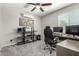 Cozy office space featuring neutral walls, ceiling fan, and organized desk area with natural light from the window at 3358 W Sandra Ter, Phoenix, AZ 85053